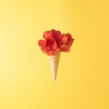 Ice cream cone with red tulip flowers to yellow background. Minimal spring concept. Flat lay Royalty Free Stock Photo
