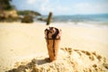 Ice cream cone on sand beach background - Melting ice cream on beach sea in summer hot weather ocean landscape nature outdoor