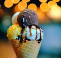 ice cream cone with 3 scoops of vanilla, chocolate and mango balls Royalty Free Stock Photo