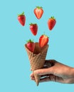 Ice cream cone with strawberries on blue background. Minimal summer concept Royalty Free Stock Photo