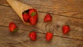 Ice cream cone with strawberries on a wooden background Royalty Free Stock Photo