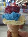 An ice cream cone with three flavors