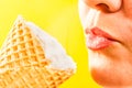 Ice cream cone by to women lips