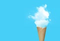 Ice cream cone with white cloud in blue background. Royalty Free Stock Photo