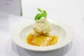 Ice cream with crepes in orang syrup on restaurant table Royalty Free Stock Photo