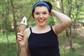 Ice cream. Cute and cheerful woman with ice cream in hand. Tasty