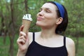 Ice cream. Cute woman with ice cream in hand. Tasty dessert.