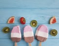 Ice cream summer fruits dessert fresh rustic flavor on a blue wooden background, grapefruit, lemon, kiwi, pattern, strawberry Royalty Free Stock Photo