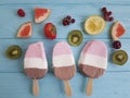 Ice cream summer fruits milk dessert natural flavor on a blue wooden background, grapefruit, lemon, kiwi, pattern, strawberry Royalty Free Stock Photo