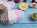 Ice cream fruits dessert on a blue wooden background, grapefruit, lemon, kiwi, pattern, strawberry Royalty Free Stock Photo