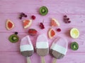 Ice cream fruits refreshment flavor on a pink wooden background, strawberry grapefruit, lemon, kiwi, pattern Royalty Free Stock Photo