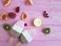 Ice cream fruits refreshment freeze delicious flavor on a pink wooden background, strawberry grapefruit, lemon, kiwi, pattern Royalty Free Stock Photo