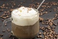 Ice cream and Glass with coffee. Coffee beans scattered on table