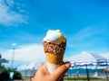 Ice cream in hand on beach and blue sky background Royalty Free Stock Photo