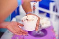 Ice cream in a hand in a cardboard cup