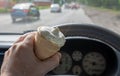 Ice cream in the hand of the driver of the car