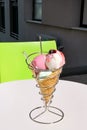 Ice cream holders on table. Strawberry, mint, vanilla with sour cherry ice cream in large waffle cone in holder. Royalty Free Stock Photo