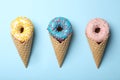 Ice cream made with donuts on blue background, flat lay