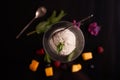 Ice cream with mascarpone cheese in a glass ice-cream bowl decorated with mint leaves on a dark background with slices of mango, b Royalty Free Stock Photo