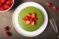 Ice cream matcha cheesecake on white plate.