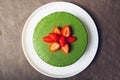 Ice cream matcha cheesecake on white plate.