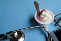 Ice cream medical concept. Stethoscope on doctor desk. Blue background Royalty Free Stock Photo