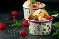 Ice Cream in paper cup with raspberry fruit and caramel sauce Royalty Free Stock Photo