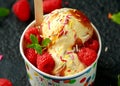 Ice Cream in paper cup with raspberry fruit and caramel sauce Royalty Free Stock Photo