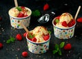 Ice Cream in paper cup with raspberry fruit and caramel sauce Royalty Free Stock Photo