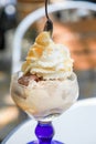 Ice cream parlors cup of nut and chocolate with whipped cream and advocaat egg liqueur outdoors Royalty Free Stock Photo