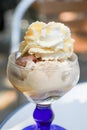 Ice cream parlors cup of nut and chocolate with whipped cream and advocaat egg liqueur outdoors Royalty Free Stock Photo