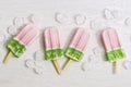 Ice cream pink half green. The concept of summer. Strawberry ice cream on a stick.