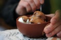 Ice cream poured with hot milk chocolate in a plate with a spoon in hands. Royalty Free Stock Photo