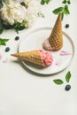 Ice cream scoops and peonies over white background, copy space Royalty Free Stock Photo