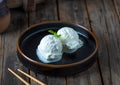 ice cream scoops served in a dish isolated on wooden background side view of dessert Royalty Free Stock Photo