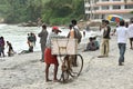 Ice cream seller on a busy beach with bicycle