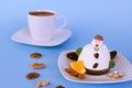 Ice cream in the shape of edible snowman on white plate and coffee cup close up. Top view. Creative idea for Christmas. Royalty Free Stock Photo