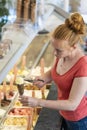 Ice cream shop with a saleswoman preparing an ice cream chocolate cone