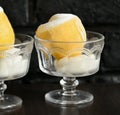 Ice cream sorbet in lemon and glass on dark background Royalty Free Stock Photo