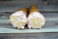 Ice-cream of special flavors in crispy wafer cones, melting cold ice cream twirl in a wafer biscuits on wooden background