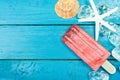 Ice cream sticks with ice and star fish on wooden background. Royalty Free Stock Photo