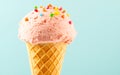 Ice cream. Strawberry or raspberry flavor icecream in waffle cone over blue background