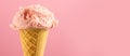 Ice cream. Strawberry or raspberry flavor icecream in waffle cone over pink background. Sweet dessert