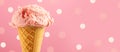 Ice cream. Strawberry or raspberry flavor icecream in waffle cone over pink polka dots background Royalty Free Stock Photo