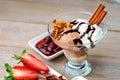 Ice cream sundae, chocolate, walnuts, sliced strawberry and cherry jam Royalty Free Stock Photo