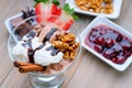 Ice cream sundae, chocolate, walnuts, sliced strawberry and jam Royalty Free Stock Photo