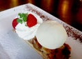 Ice cream vanila serve on apple cake with whipped cream and strawberry on beautiful white plate Royalty Free Stock Photo