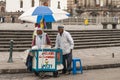 2 ice cream vendors on square in front of San Francisco church, Quito, Ecuador