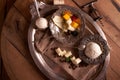 Ice cream in a vintage ice-cream bowl on a vintage metal tray with an assortment of cheeses, blackberries on a wooden table.