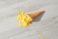 Ice cream in a waffle cone fell on floor Royalty Free Stock Photo